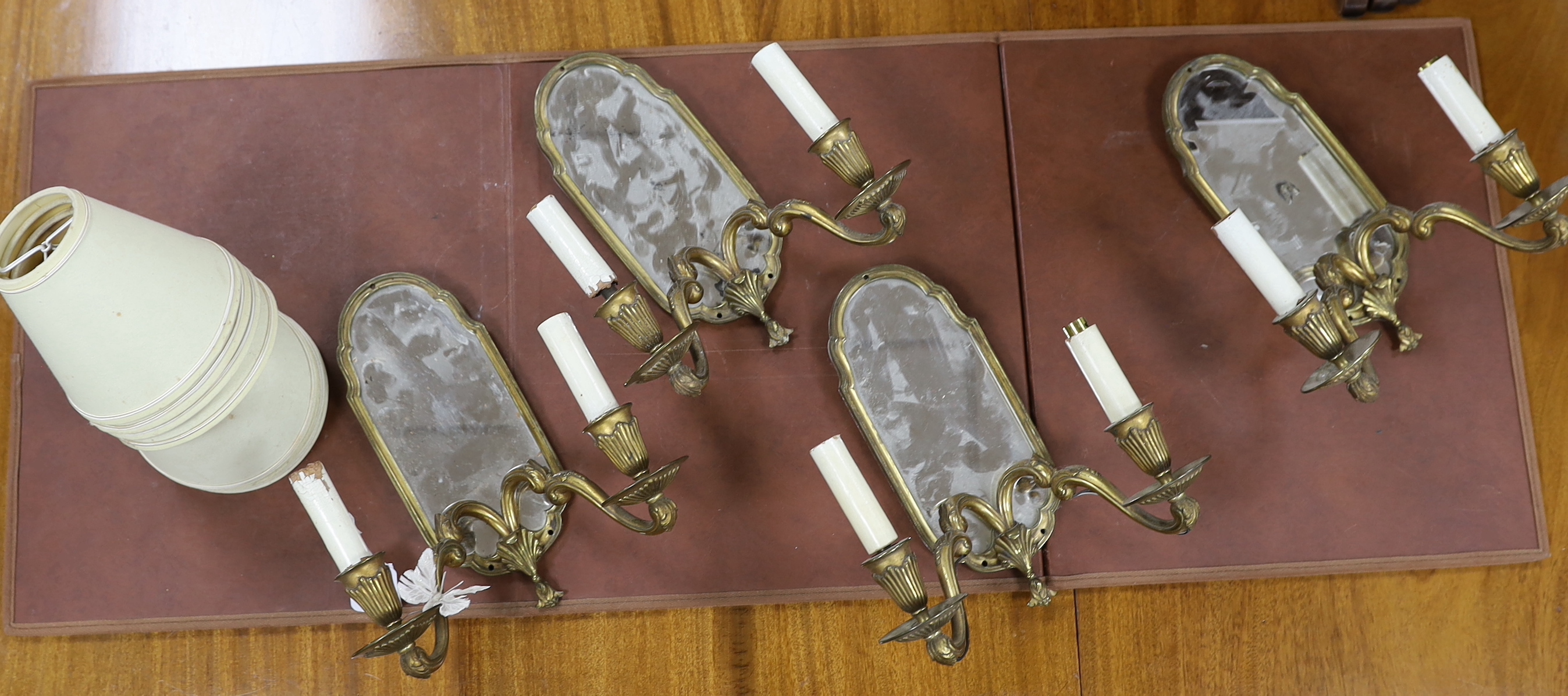 A set of four twin-branch mirror-backed wall sconces, 30cm high